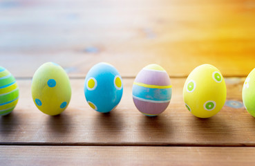 colored easter eggs on wooden surface