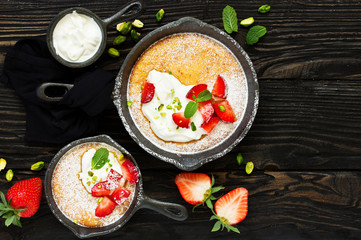 almond pie with cream and strawberries. View from above.