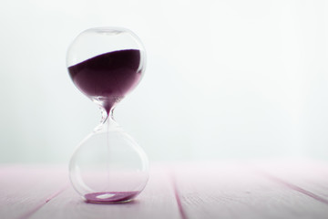 Hourglass with pink sand.