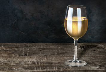 Glass of white wine on a wooden table