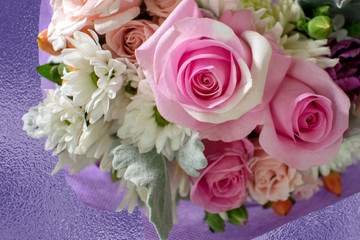 Pink roses in center of pretty bouquet of flowers