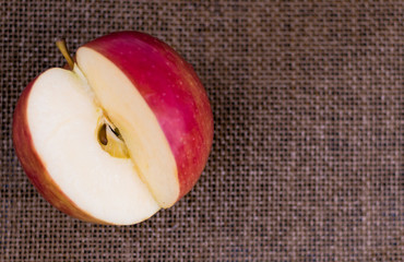 Apple cut on a dark brown background.