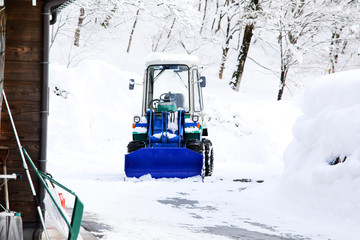 Snow loader for removes snow on the road in the village