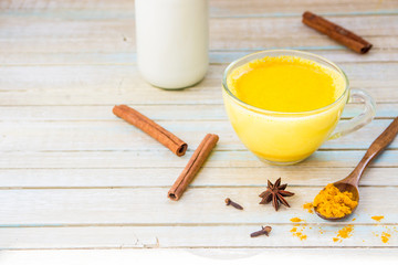 Golden turmeric milk with cinnamon. Healthy and aromatic detox beverage