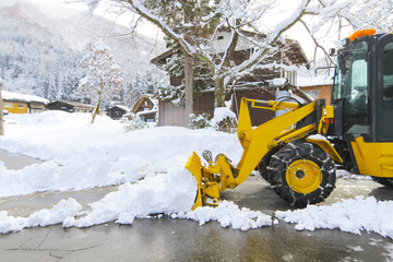 snow loader for removes snow on the road in the village