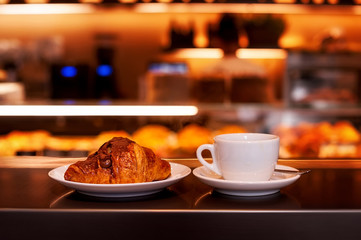 cup of coffee and croissan with chocolate