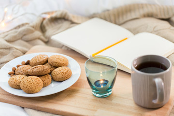 cookies, tea and candle in holder at home