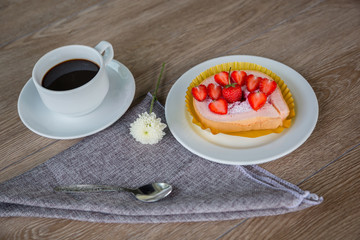 Cake and strawberries on wood background.