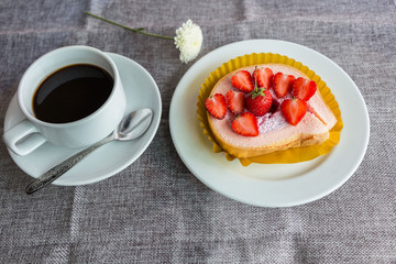 Cake and strawberries on wood background.