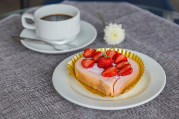 Cake and strawberries on wood background.