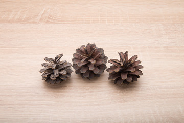 Pine cones on a wooden table with oak texture