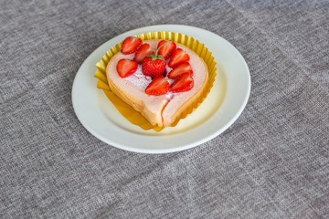 Cake and strawberries on wood background.