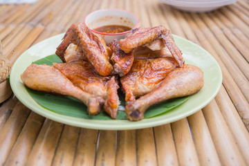 Baked chicken wings in pan on wooden table. 