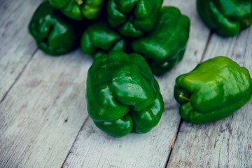 Green peppers on table.