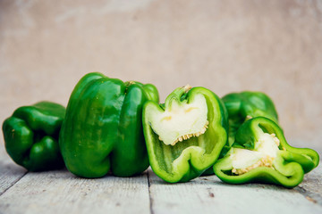 Photo of sliced colorul peppers over wooden table