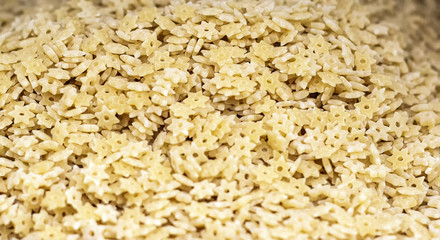 A background of dry pasta in the form of asterisks