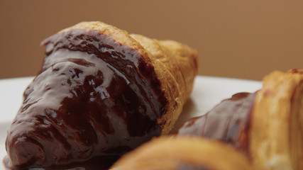 three croissant with a chocolate topping on a half