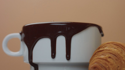 slowmotion of hot chocolate take out of cup making nice smooges on white cup