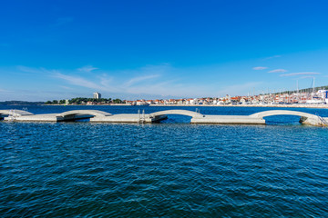Landscape or seascape view of an old mediterranean village above the new modern beach structure,  Dalmatia in Croatia