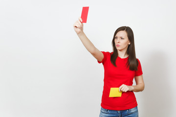 European serious severe young woman, football referee hold choose yellow and red soccer cards,...