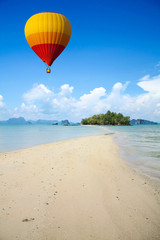 Colorful hot air balloon fly over the sea.