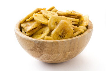 Banana chips in wooden bowl isolated on white background

