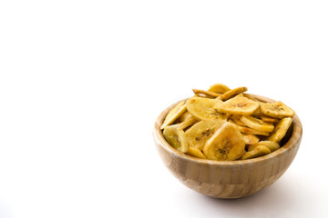 Banana chips in wooden bowl isolated on white background. Copyspace

