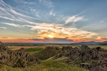Beautiful landscape of a colorful sunset sky above rocky mountains, Dobrogea, Romania