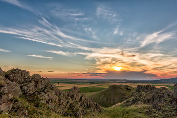 Beautiful landscape of a colorful sunset sky above rocky mountains, Dobrogea, Romania