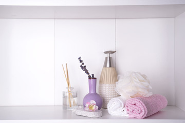 Various spa and beauty threatment products on white shelf