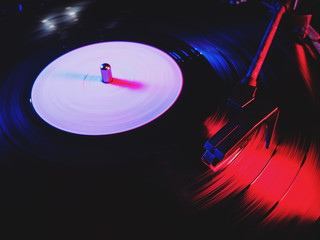 Phono or capsule head of reading an LP turntable spinning. Close up of turntable vinyl stylus going...