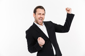 Portrait of happy businessman clenching fists like winner or successful person being happy to achieve his goals, isolated over white background