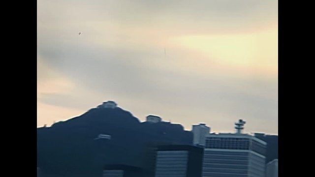 Panorama close up on Victoria Peak skyline from Hong Kong downtown. Historic restored footage on 1980s with few skyscrapers.