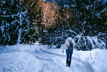 Young female hiker in winter mountain wood