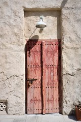 Ancient wooden Arab door in a stone wall.