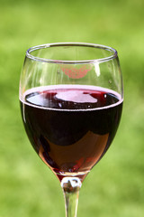 Close up of red wine in a glass with red lipstick print on the rim