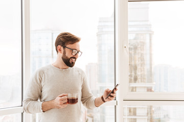 Fototapeta premium Portrait of a smiling man using mobile phone