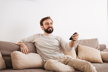 Portrait of a smiling man holding remote control