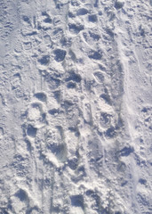 Footprints on white snow. Footprints in the snow from the feet.