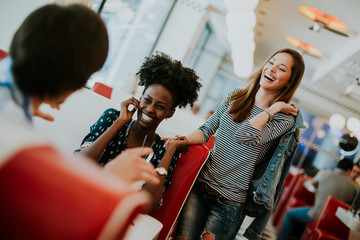 Young multiracial friends enjoying in the diner