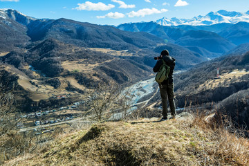 Fototapeta premium Hiker takes photo of beautiful mountains