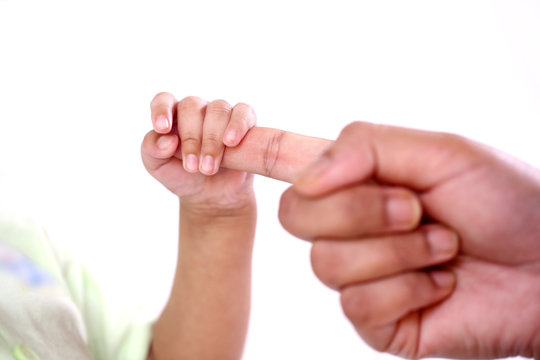 Newborn baby holding mother's hand