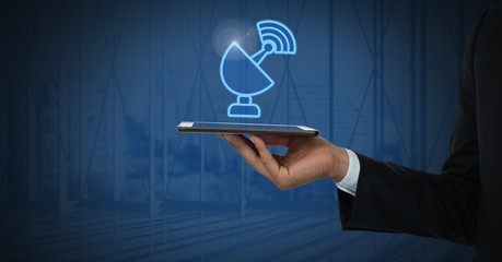 Hand holding tablet with signal icon