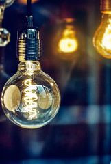 Electric lighting bulb with spiral. Background copyspace.