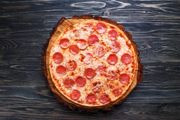 Delicious pizza with pepperoni and cheese served on wood, flat lay. Italian food, restaurant menu photo