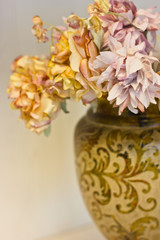 Pink and orange chrysanthemums in a white vase. Artificial silk flowers in the interior