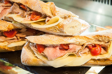 sandwich of fresh bread with tomatoes, Parmesan and ham