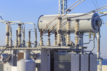 Powerful electrical transformer at high-voltage substation. Industrial electrical equipment.