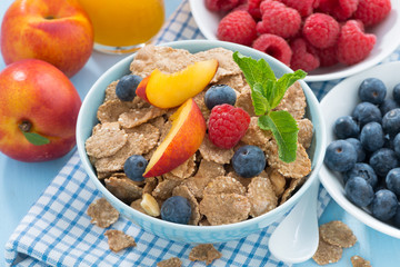 healthy breakfast with flakes, fresh fruit and berries, orange juice, close-up