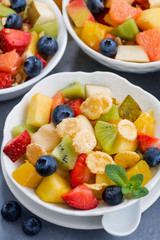 healthy breakfast with fruit salad, vertical, closeup